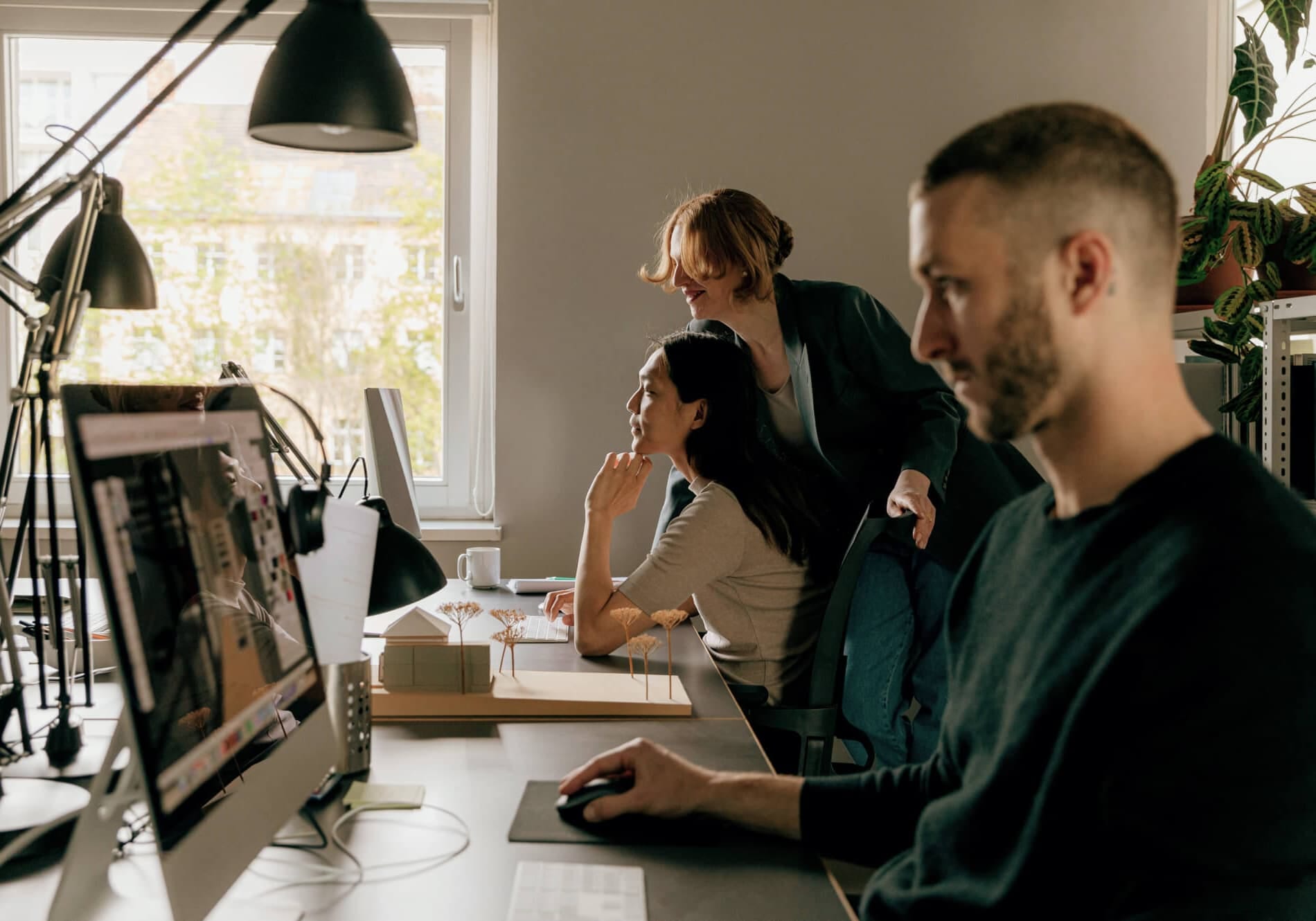 Colleagues collaborating at the office, a workplace supported by approved occupational health services